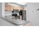 Cozy kitchen with stainless appliances, modern white subway tile backsplash, and gray countertops at 8801 Latrec Ave # 8107, Orlando, FL 32819