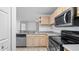 Kitchen featuring tile floor and modern black and stainless appliances at 8801 Latrec Ave # 8107, Orlando, FL 32819