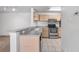 Open concept kitchen with stainless appliances and light wood cabinets at 8801 Latrec Ave # 8107, Orlando, FL 32819