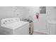 Laundry room featuring washer, dryer, water heater and wire shelving at 8801 Latrec Ave # 8107, Orlando, FL 32819