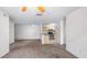 Spacious living room featuring neutral carpet with open view to the kitchen at 8801 Latrec Ave # 8107, Orlando, FL 32819