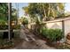 View of the alleyway behind the house, with a wooden fence and greenery, providing access to the property at 911 S Oak Ave, Sanford, FL 32771