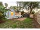 Charming backyard featuring a brick patio, lush grass, and a privacy fence perfect for outdoor entertaining at 911 S Oak Ave, Sanford, FL 32771