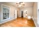 Bedroom with hardwood floors, natural light, and access to bathroom at 911 S Oak Ave, Sanford, FL 32771