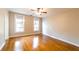 Bright bedroom featuring hardwood floors, ceiling fan and double windows at 911 S Oak Ave, Sanford, FL 32771