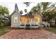 Charming home featuring string lights and a brick paved driveway at 911 S Oak Ave, Sanford, FL 32771