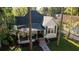 Charming two-story home featuring a welcoming front porch with rocking chairs and a well-manicured front yard at 911 S Oak Ave, Sanford, FL 32771