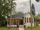 Charming home with front porch, rocking chairs, fresh landscaping, and a welcoming entrance at 911 S Oak Ave, Sanford, FL 32771