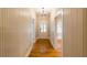 Hallway with a gleaming hardwood floor and natural light throughout at 911 S Oak Ave, Sanford, FL 32771