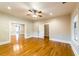 Open living room with hardwood floors, white trim, and ample natural light at 911 S Oak Ave, Sanford, FL 32771