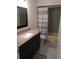 Bathroom featuring updated vanity with granite counters and shower/tub combo at 943 Millenbeck Ave, Deltona, FL 32725