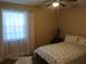 Inviting bedroom with floral bedding, natural light, and warm, neutral tones at 943 Millenbeck Ave, Deltona, FL 32725