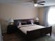 Comfortable bedroom featuring a ceiling fan, large window, and stylish furnishings at 943 Millenbeck Ave, Deltona, FL 32725