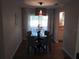 Cozy dining room featuring a round table, four chairs, and natural light from a window at 943 Millenbeck Ave, Deltona, FL 32725