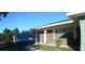 Home exterior displaying the red brick, neutral siding, white door, and landscaped front yard at 943 Millenbeck Ave, Deltona, FL 32725