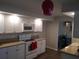Well-lit kitchen with white appliances, granite countertops, and white cabinets at 943 Millenbeck Ave, Deltona, FL 32725