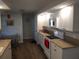 Functional kitchen with white appliances, granite countertops, and ample cabinet space at 943 Millenbeck Ave, Deltona, FL 32725