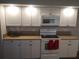 Updated kitchen with white cabinets, granite countertops, and modern appliances at 943 Millenbeck Ave, Deltona, FL 32725