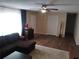 Spacious living area with wood flooring, a plush sectional, neutral walls, and ample natural light at 943 Millenbeck Ave, Deltona, FL 32725