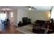 Inviting living room with wood floors, a comfortable sectional sofa, and a view into the dining area at 943 Millenbeck Ave, Deltona, FL 32725