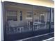 View of the screened-in patio with neutral colors and an outdoor dining set at 943 Millenbeck Ave, Deltona, FL 32725