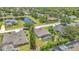 Aerial view of property featuring a screened-in pool, lush landscaping, and neighborhood pond at 10417 Oakview Pointe Ter, Gotha, FL 34734