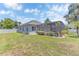 Expansive backyard featuring a screened-in pool, lush landscaping, and privacy fence at 10417 Oakview Pointe Ter, Gotha, FL 34734