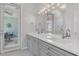 Modern bathroom featuring double sinks, a large mirror, and sleek fixtures at 10417 Oakview Pointe Ter, Gotha, FL 34734