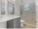 Updated bathroom with gray vanity, modern fixtures, and glass shower at 10417 Oakview Pointe Ter, Gotha, FL 34734