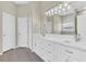 Bright bathroom with double sinks, white cabinets, and stylish lighting at 10417 Oakview Pointe Ter, Gotha, FL 34734