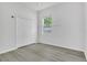 Bright bedroom with hard surface floors, a closet, and a window at 10417 Oakview Pointe Ter, Gotha, FL 34734