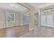 Spacious living room with hardwood floors, neutral walls, archways, and a view of the front yard at 10417 Oakview Pointe Ter, Gotha, FL 34734