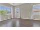 Light-filled main bedroom featuring hardwood floors, neutral walls, and large windows with white curtains at 10417 Oakview Pointe Ter, Gotha, FL 34734