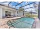 Inviting screened-in pool with a brick-paved patio and outdoor seating at 10417 Oakview Pointe Ter, Gotha, FL 34734