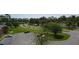 Aerial view of a parking lot and surrounding community with mature trees and well-maintained grounds at 105 Wood Duck Cir # D, Daytona Beach, FL 32119