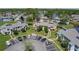 Wide aerial view showing a community with ample parking, ponds, and meticulously kept grounds at 105 Wood Duck Cir # D, Daytona Beach, FL 32119