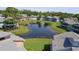 Scenic aerial view showcasing a tranquil pond surrounded by well-maintained townhouses and lush greenery at 105 Wood Duck Cir # D, Daytona Beach, FL 32119