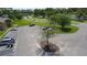 Aerial view of a parking area with cars, landscaping, and a view of surrounding buildings at 105 Wood Duck Cir # D, Daytona Beach, FL 32119