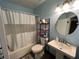 Functional bathroom featuring a tub-shower combination, pedestal sink and storage shelves at 105 Wood Duck Cir # D, Daytona Beach, FL 32119