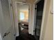 View of a sunlit bedroom featuring hardwood floors, neutral walls and an adjoining bathroom at 105 Wood Duck Cir # D, Daytona Beach, FL 32119