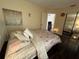 Cozy bedroom featuring a queen bed, dark wood floors, and an open doorway at 105 Wood Duck Cir # D, Daytona Beach, FL 32119