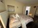 Cozy bedroom featuring a queen bed, dark wood floors, and an open doorway at 105 Wood Duck Cir # D, Daytona Beach, FL 32119