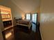 Relaxing bedroom boasts dark wood floors and natural light from the sliding glass door at 105 Wood Duck Cir # D, Daytona Beach, FL 32119