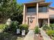 Inviting townhome entrance with manicured garden, patriotic decor, and neutral tones at 105 Wood Duck Cir # D, Daytona Beach, FL 32119