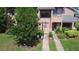 Charming townhome featuring a welcoming entrance with lovely landscaping and a decorative wreath at 105 Wood Duck Cir # D, Daytona Beach, FL 32119