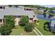 Charming townhouse near a lake featuring manicured landscaping and a walkway to the entrance at 105 Wood Duck Cir # D, Daytona Beach, FL 32119