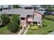 Charming two-story townhouse with well-manicured landscaping, a decorative wreath, and a gray roof at 105 Wood Duck Cir # D, Daytona Beach, FL 32119