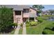 Inviting townhome entrance with a charming wreath and beautifully landscaped front yard at 105 Wood Duck Cir # D, Daytona Beach, FL 32119