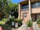 Inviting townhome entrance with manicured garden, patriotic decor, and neutral tones at 105 Wood Duck Cir # D, Daytona Beach, FL 32119