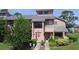 Charming townhome featuring a well-manicured lawn, decorative wreath, and welcoming entryway at 105 Wood Duck Cir # D, Daytona Beach, FL 32119